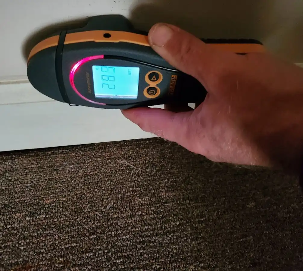 Moisture detection at baseboard during Storm Damage Restoration in Red Bank